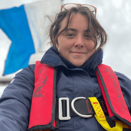 Eve is aboard the Project Seagrass boat, Gwen. She is wearing jacket and a life belt.