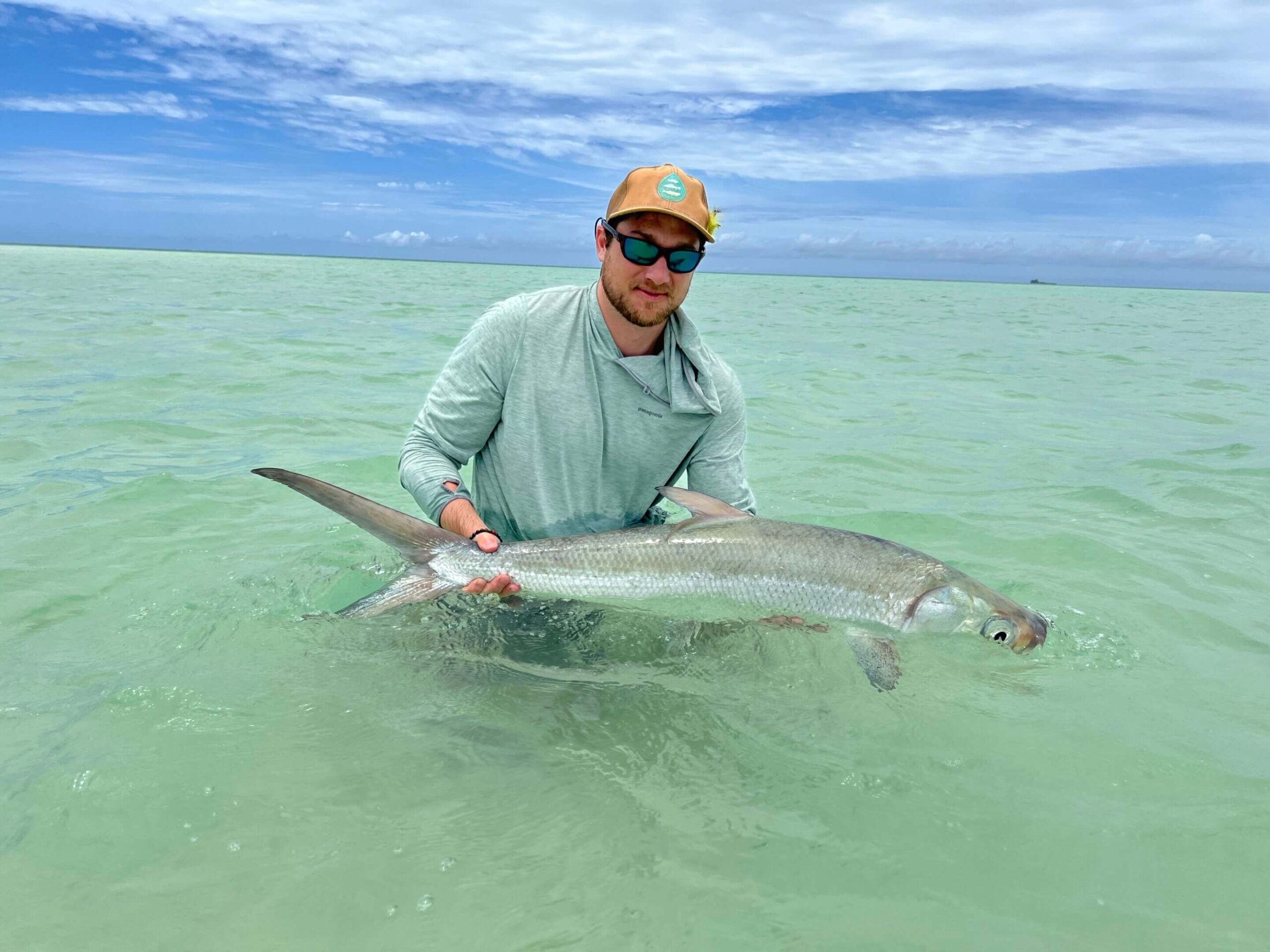 Study lead author Lucas Griffin holds a milkfish in a tidal flats habitat in St. François Atoll, Seychelles. Credit: Andy Danylchuk, University of Massachusetts Amherst