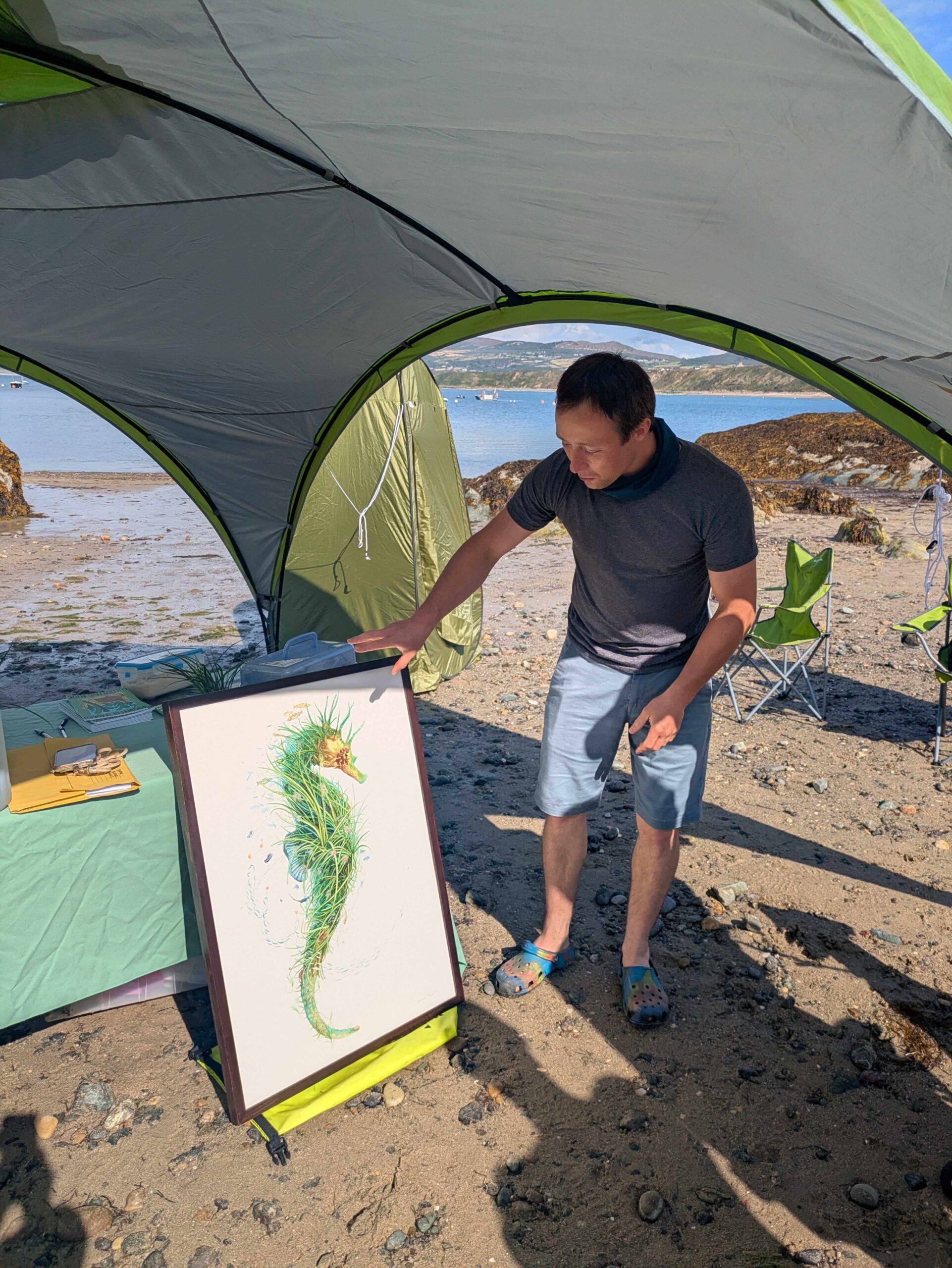Artist Oliver Leger introducing his artwork 'Ambassador' at Porthdinllaen beach