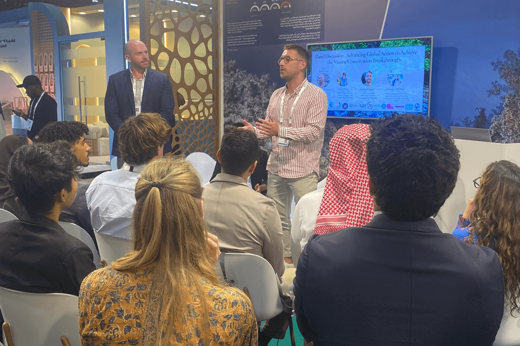 Ben stands in front of an audience at the IUCN World Conservation Congress.