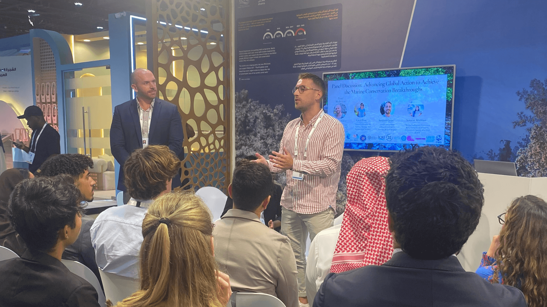 Ben stands in front of an audience at the IUCN World Conservation Congress.