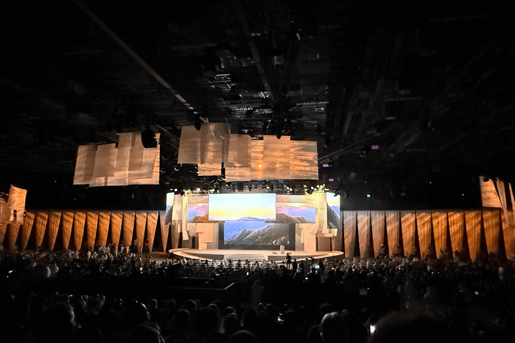 A large conference hall with a stage at the front