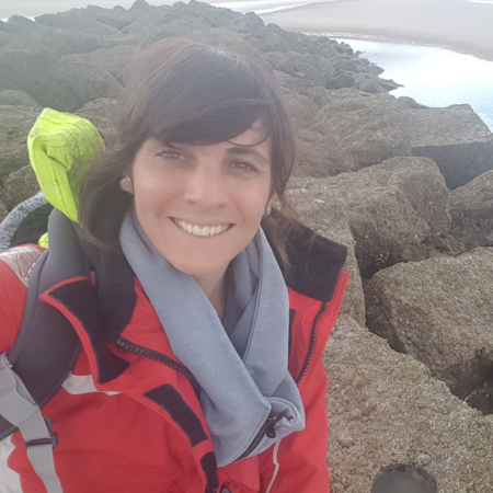 Ally Evans on a rocky beach