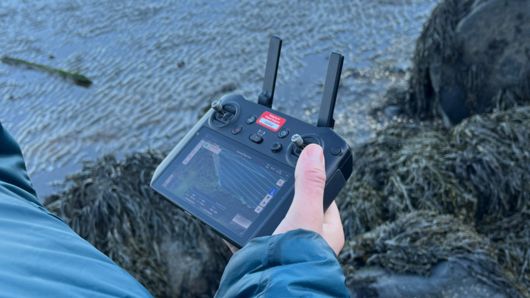 Drone controller being used next to kelp bed