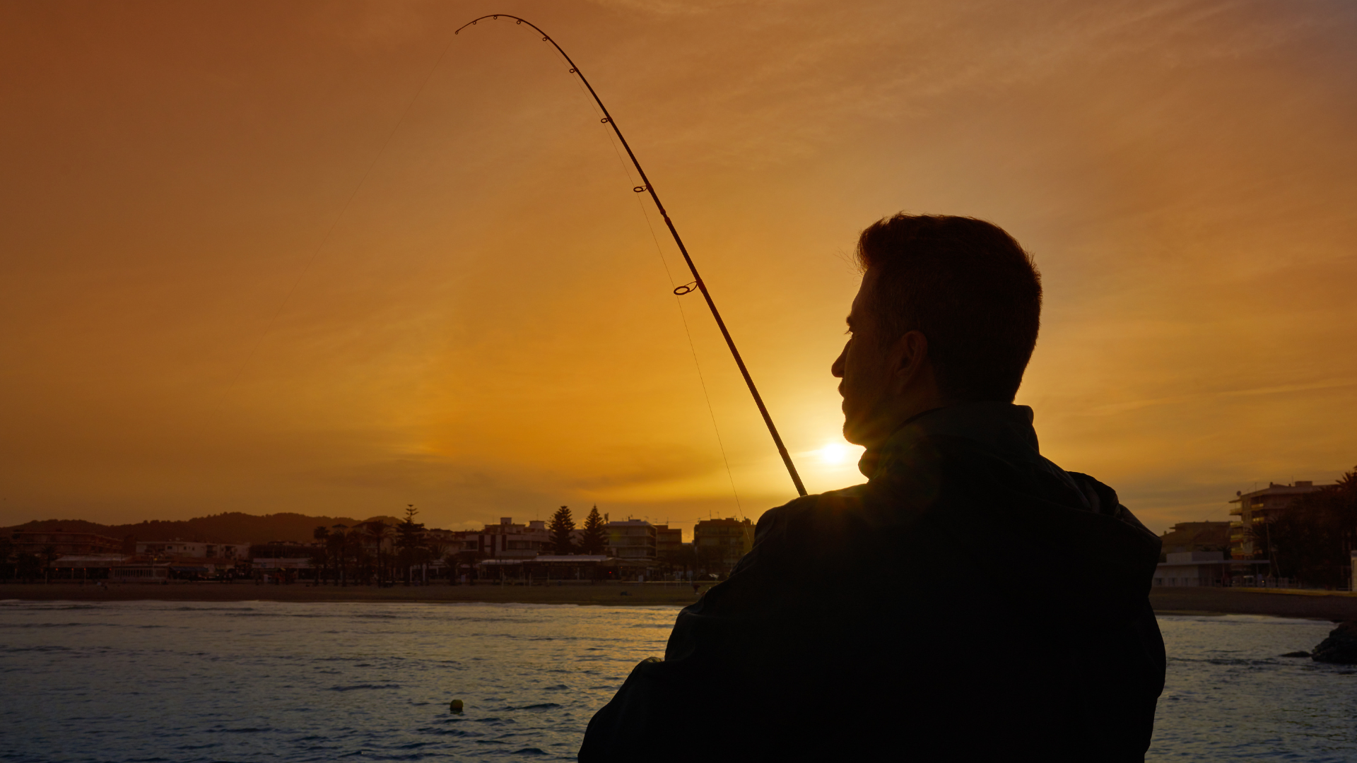 Sunset shot of man fishing